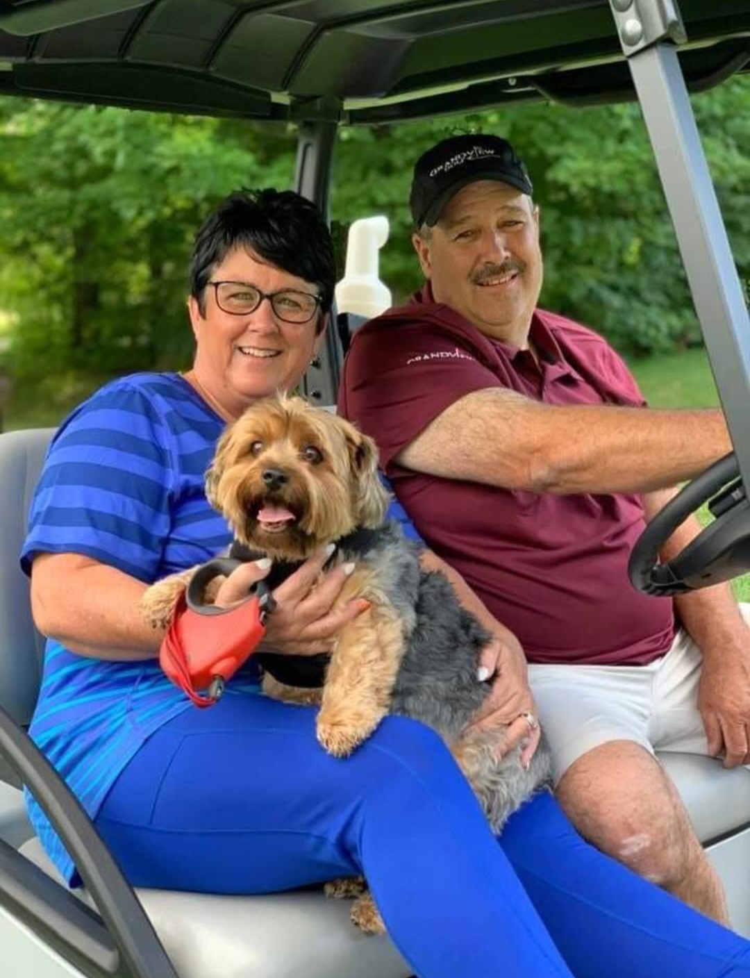 New owners with dog on golf cart